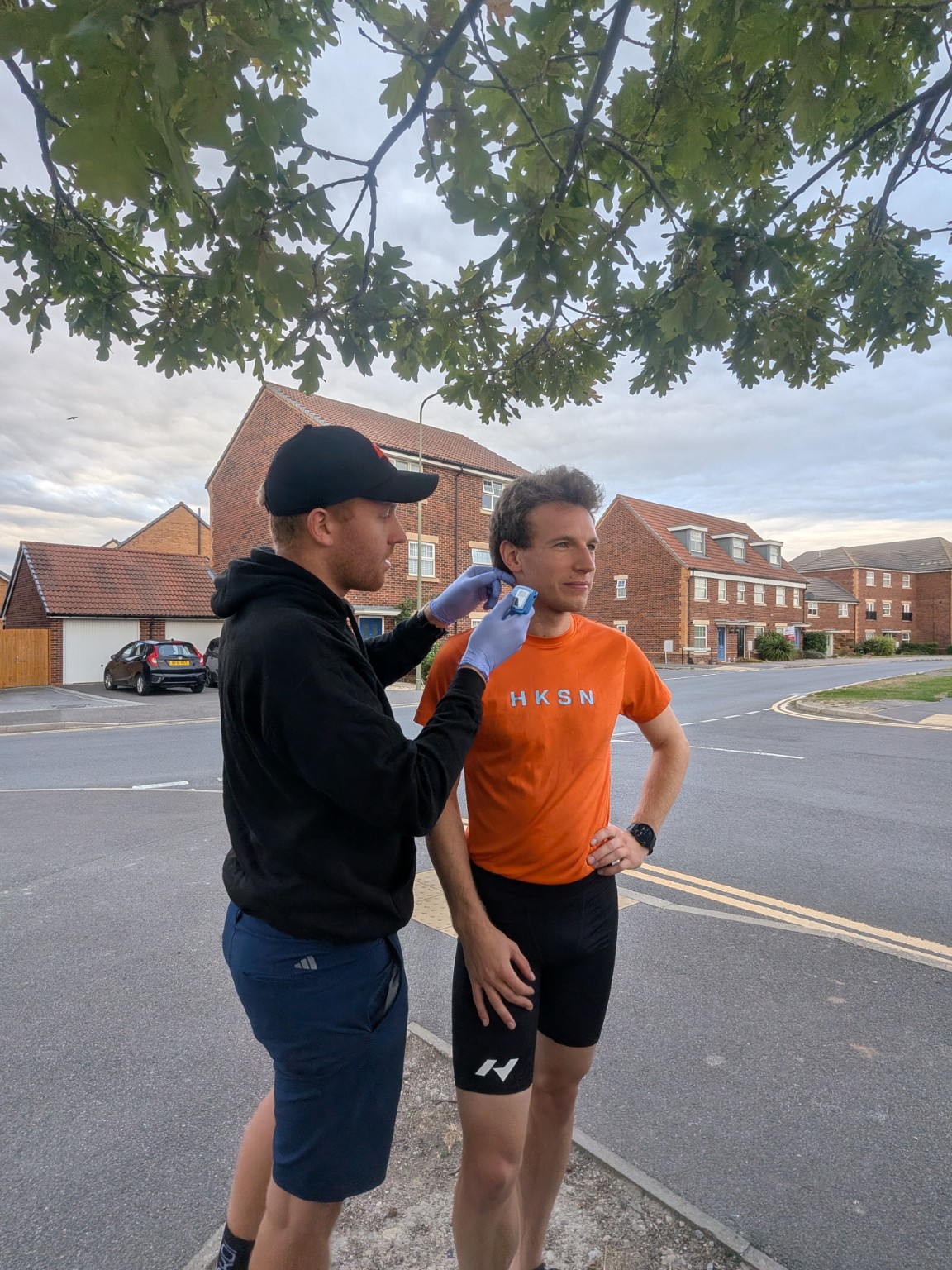 Henry taking an ear-lobe blood lactate sample from a runner in Didcot